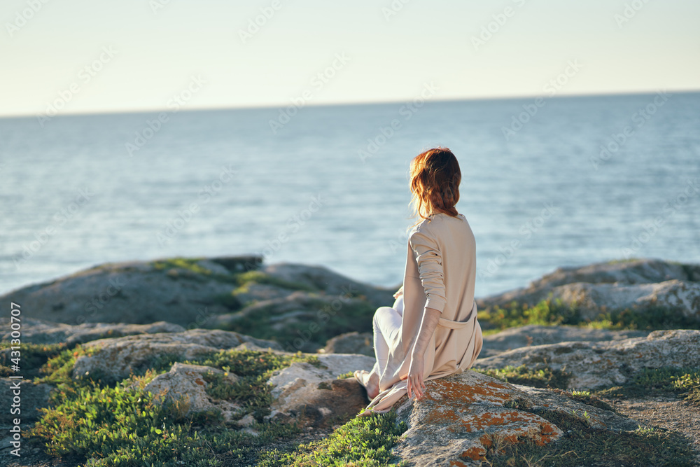 romantic woman in the mountains near the sea on nature landscape