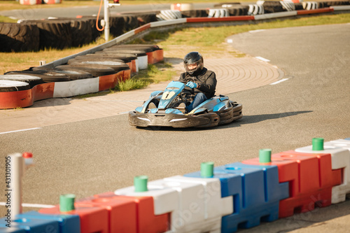 Man with helmet drives go-kart on a racing track  © Marianna
