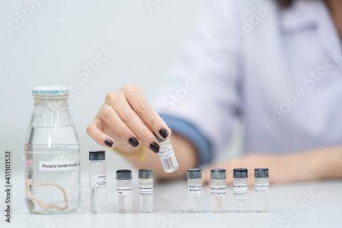 A young woman researcher, doctor, scientist, or laboratory assistant working with plastic medical tubes to research, examine scientific experiments in a modern laboratory. Education stock photo