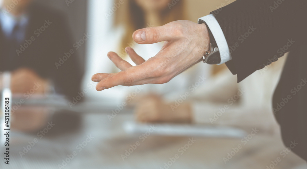 Business presentation. Unknown businessman giving a speech to colleagues or partners at corporate conference. Meeting concept Business presentation. Unknown businessman giving a speech to colleagues or partners at corporate conference. Meeting concept