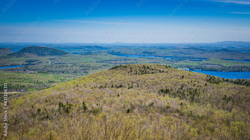 View on lake Stukely and the Eastern TOwnships mountains from the top of Mont Chauve, a mountain located in Mont Orford National Park in Quebec, Canada View on lake Stukely and the Eastern TOwnships mountains from the top of Mont Chauve, a mountain located in Mont Orford National Park in Quebec, Canada