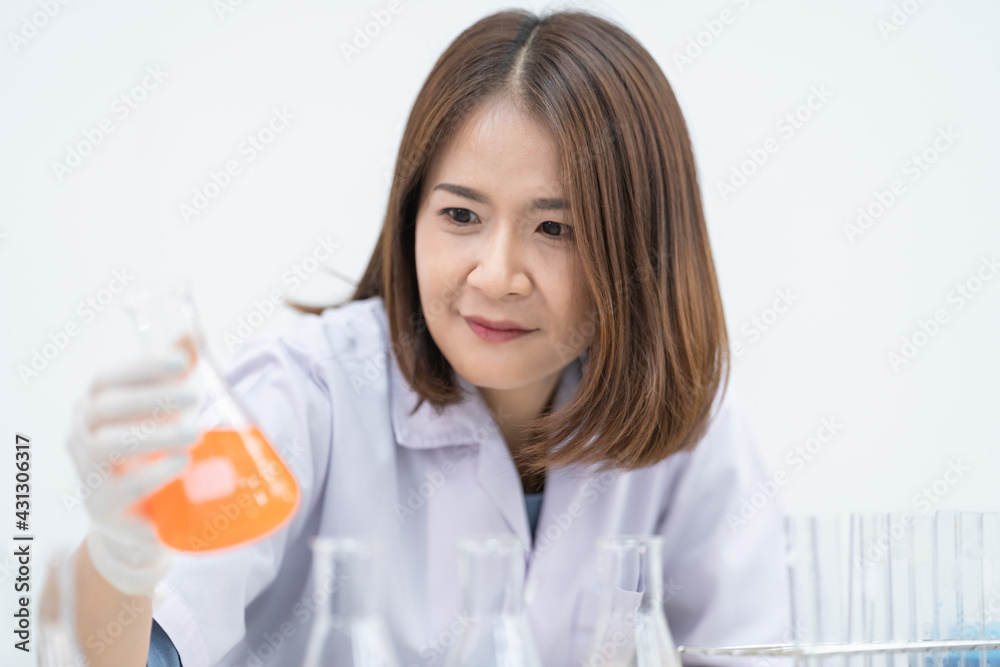 A young woman researcher, doctor, scientist, or laboratory assistant working with plastic medical tubes to research, examine scientific experiments in a modern laboratory. Education stock photo A young woman researcher, doctor, scientist, or laboratory assistant working with plastic medical tubes to research, examine scientific experiments in a modern laboratory. Education stock photo