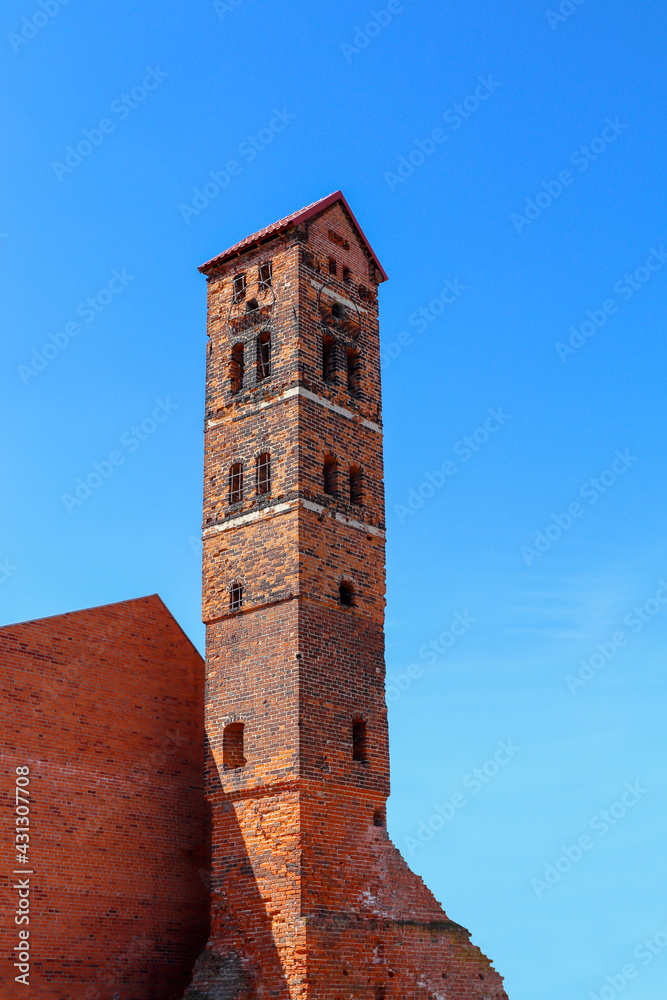 The clock tower of the Ragnit castle is made of red brick. Neman town, Kaliningrad region