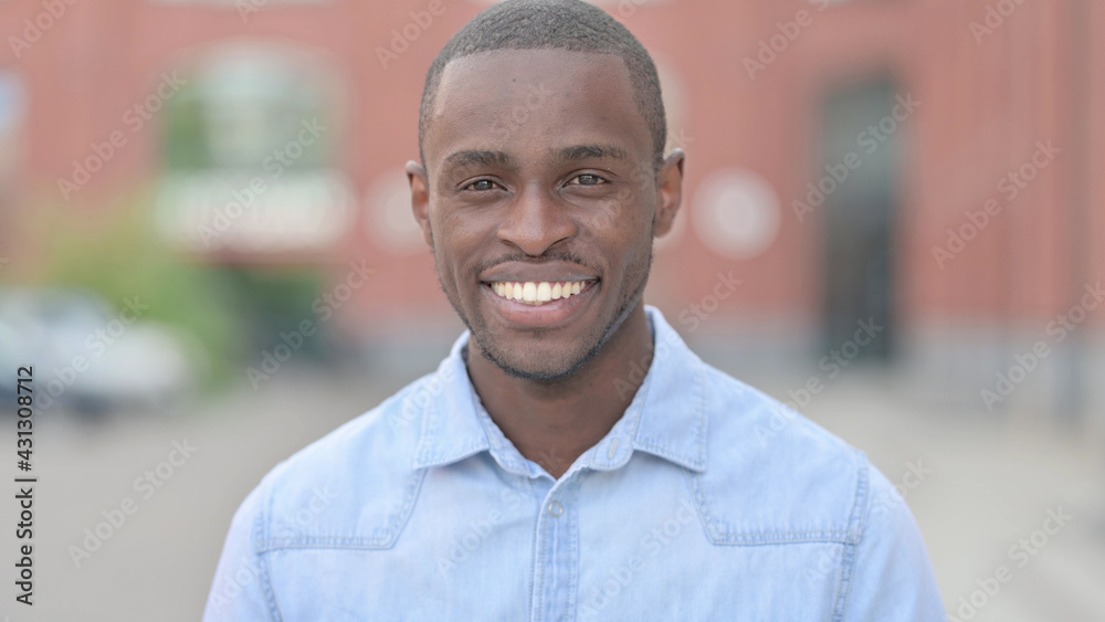 Fototapeta premium Portrait of Young African Man saying Yes by Shaking Head