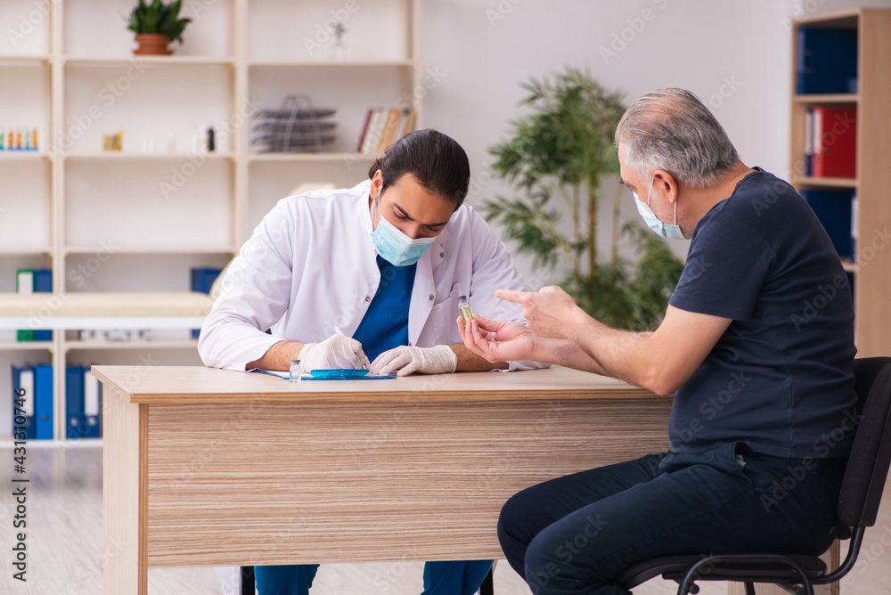Old man visiting young doctor in covid-19 vaccination concept Old man visiting young doctor in covid-19 vaccination concept