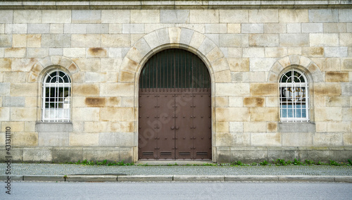Old massive door with decorative door handle and lock, all still functional © helfei