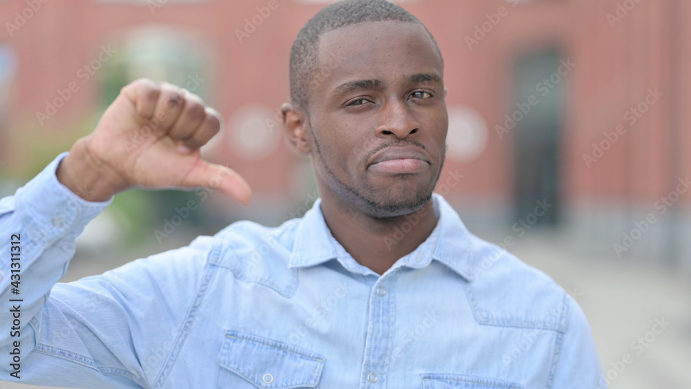 Portrait of Disappointed African Man doing Thumbs Down Portrait of Disappointed African Man doing Thumbs Down