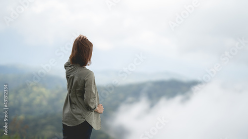 Female tourist looking at the beautiful view on the covered mountain in Nan Province, Thailand © PIPAT