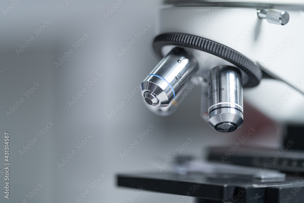 Close-up and selective focus shoot of a microscope, medical test tubes with liquid, and other modern laboratory equipment in a laboratory room. Education stock photo Close-up and selective focus shoot of a microscope, medical test tubes with liquid, and other modern laboratory equipment in a laboratory room. Education stock photo