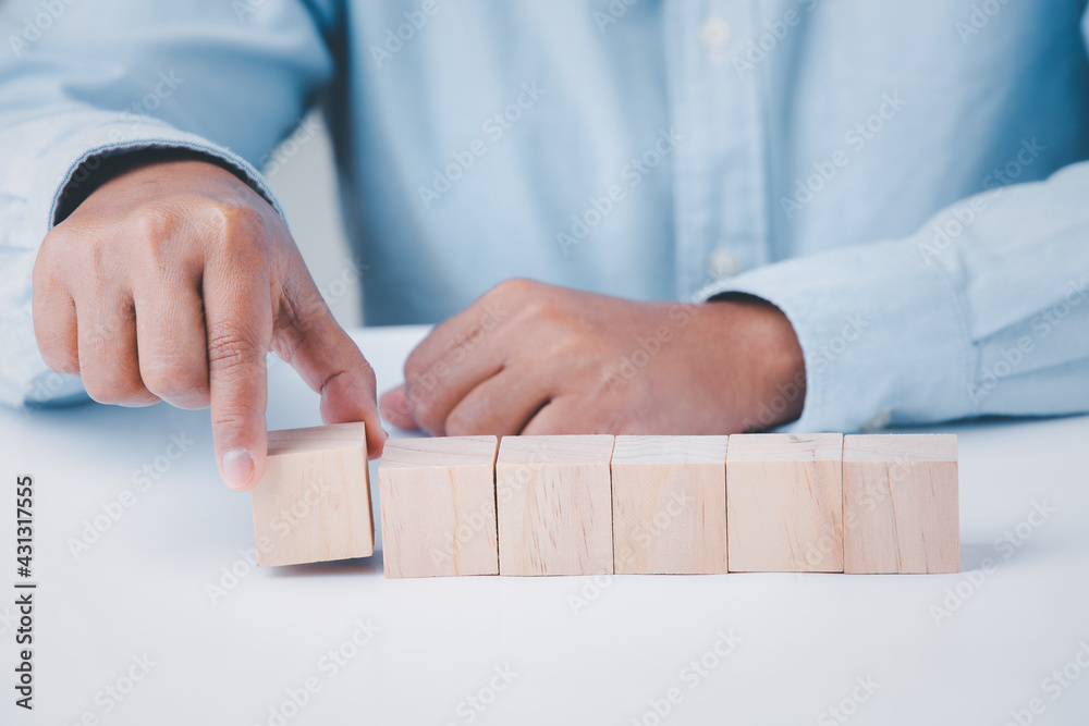 Business hand holding wooden block blank cubes creative idea on table, conceptual development business strategy success background. Business hand holding wooden block blank cubes creative idea on table, conceptual development business strategy success background.