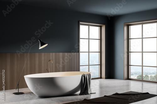 Bathroom interior with bathtub and foot towel with lamp on grey floor