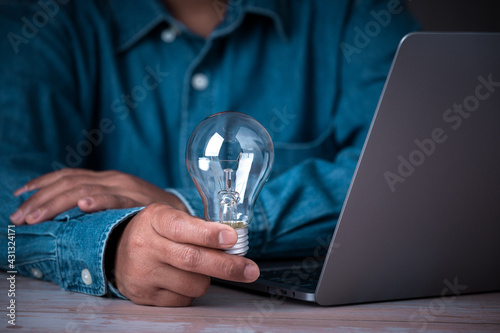 Business  hand holding light bulb technology notebook, creative new idea innovation brainstarming and solution business copy space background, thinking inspiration design for success.