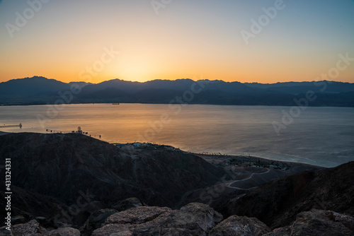 Dawn rises beyond the Aqaba mountains. Sunrise over the Red Sea. A look at Mount Shlomo, Eilat, Israel. High quality photo