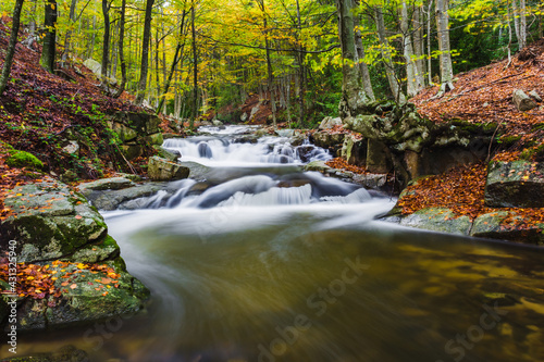 Waterfall in autumn forest photo