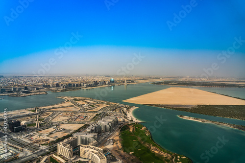 Abu Dhabi, United Arab Emirates, March 2021, Aerial view around Yas Island and Al Raha creek with Al Sail Tower building and Aldar headquarter building in the background  photo