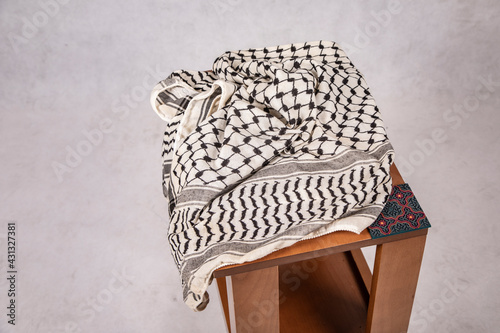 Palestinian Traditional Keffiyeh Scarf on wooden Table photo