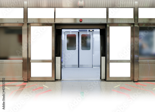 Fototapeta Naklejka Na Ścianę i Meble -  Mockup of blank poster advertising space in generic train station; OOH mock up. Straight front view of MRT platform, without people