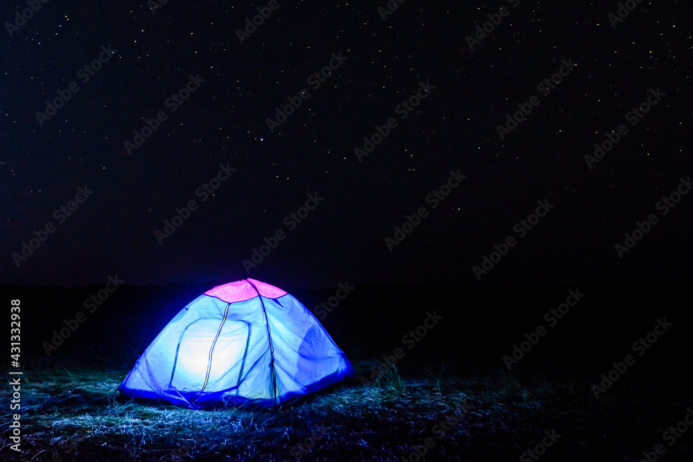 Tourist tent at night. Night sky with the many stars