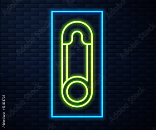 Glowing neon line Classic closed steel safety pin icon isolated on brick wall background. Vector