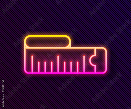 Glowing neon line Tape measure icon isolated on black background. Measuring tape. Vector
