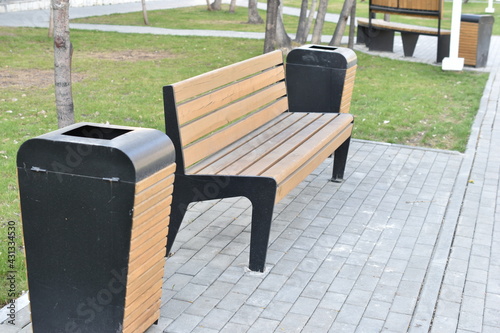 Wooden park bench in city park in summer