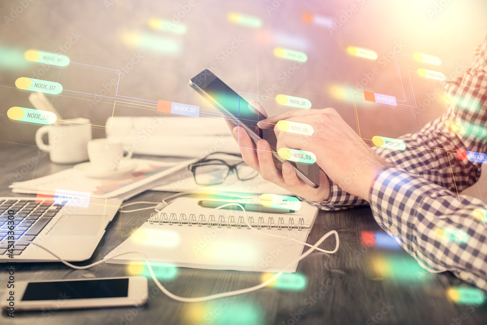 Double exposure of man's hand holding and using a digital device and data theme hologram drawing. Technology concept. Double exposure of man's hand holding and using a digital device and data theme hologram drawing. Technology concept.