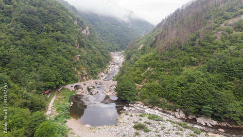 Roman Old stronework,devil bridge, from the ottoman on eastern europe, at Bulgaria. Medieval structure over the river in rhodope. Aerial view with drone of Mystic bulgarian location. Balkans valley