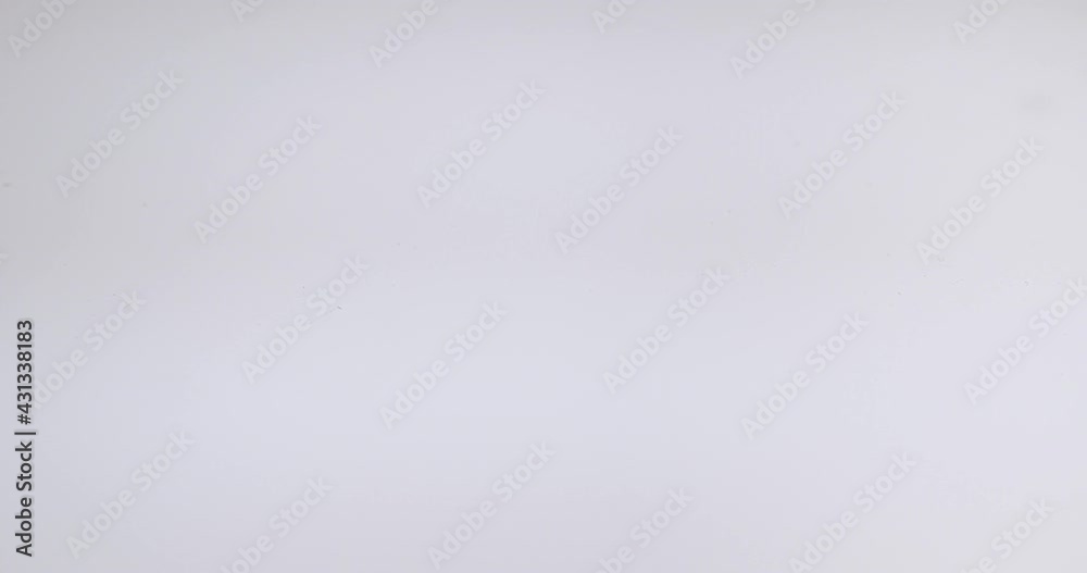 Top view of drop falls into water and diverging circles of water on white background Top view of drop falls into water and diverging circles of water on white background