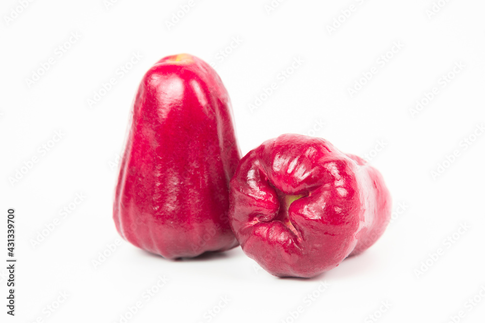 Depth of field. Group of Rose apple or Java apple or Syzygium seed with Full on wooden tray. isolated on white background. fruit flavors of sweet red gloss. Fresh fruit. Depth of field. Group of Rose apple or Java apple or Syzygium seed with Full on wooden tray. isolated on white background. fruit flavors of sweet red gloss. Fresh fruit.