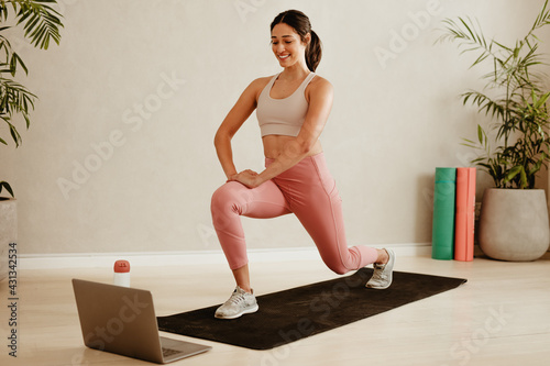 Woman exercising watching online exercise session photo