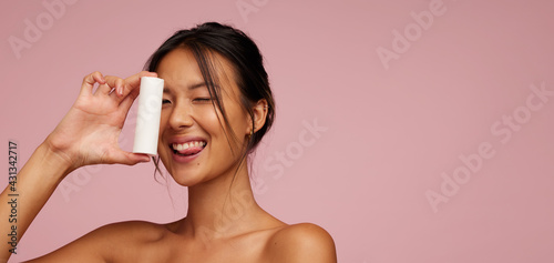 Asian female model showing a skin product