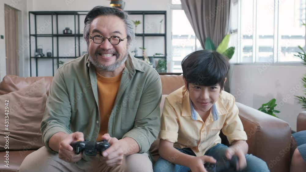 Son and dad playing video game at home Son and dad playing video game at home