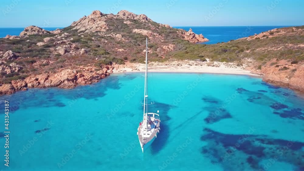 View from above, stunning aerial view of some sailboats sailing on a beautiful turquoise sea. Mortorio Island, (Isola di Mortorio, Sardinia, Italy.