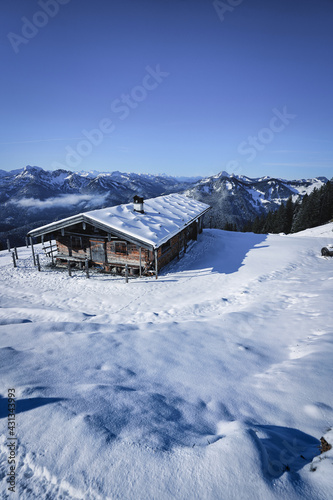 Wonderful wooden hut in snow covered mountains © Hanjin