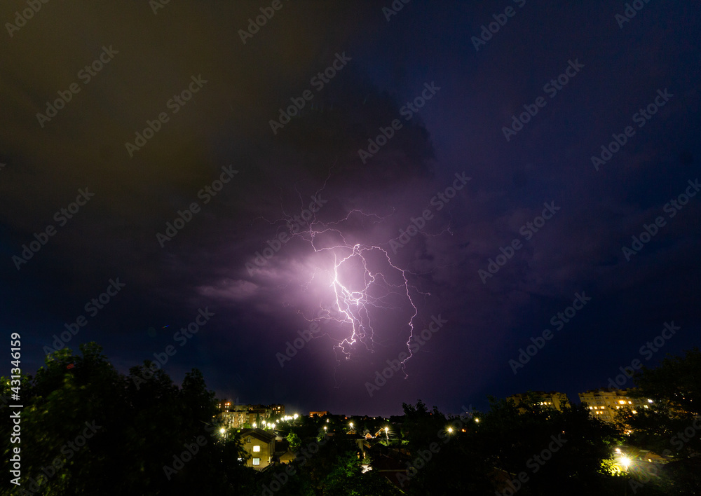 Fototapeta premium Lightning on the background of the night city. 