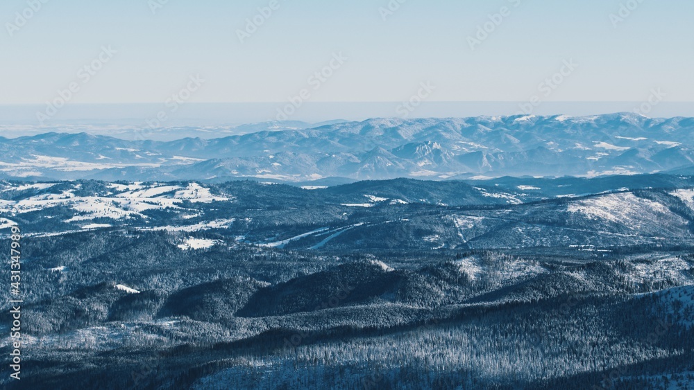 snowy mountains - Light snowfall with winds. Cloudy Sky . High quality photo