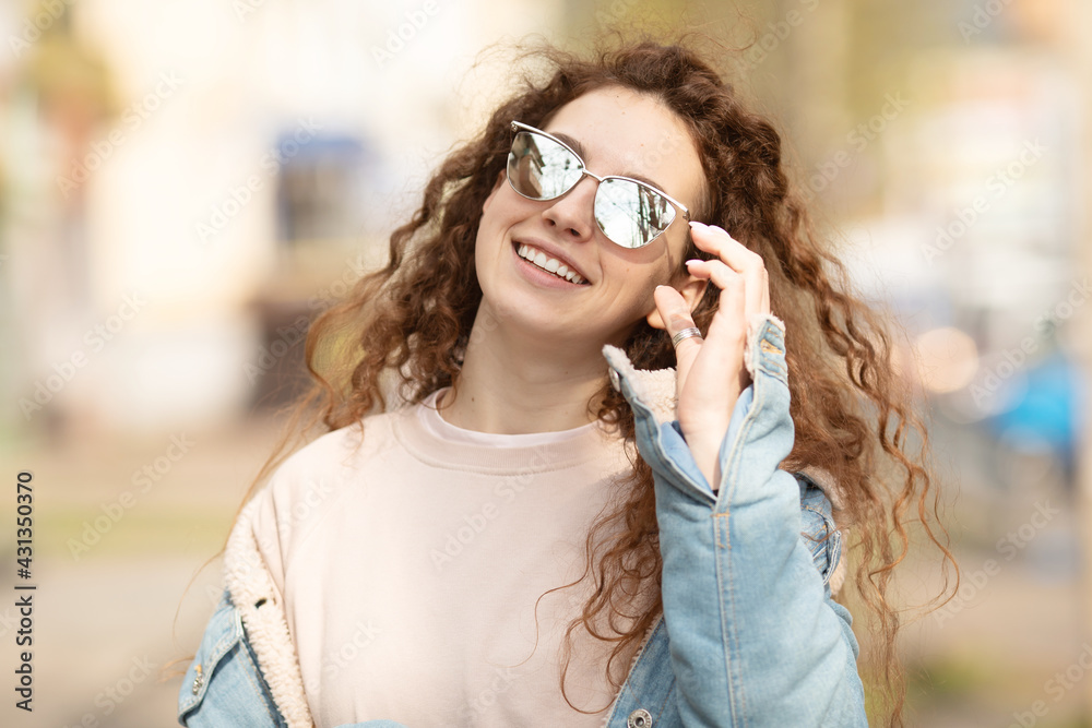 Beautiful smiling young caucasian girl with curly hair outdoors Beautiful smiling young caucasian girl with curly hair outdoors
