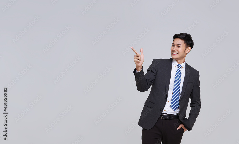 handsome and friendly face asian businessman smile in formal suit points his hands to presented to copy space on white background studio shot. handsome and friendly face asian businessman smile in formal suit points his hands to presented to copy space on white background studio shot.
