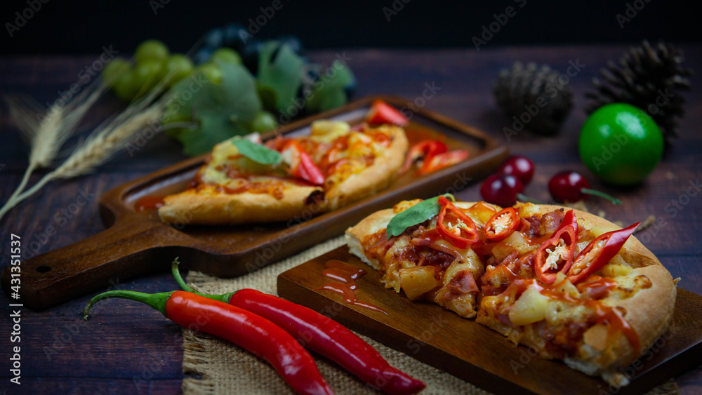 Delicious Italian Pizza with Red Chili And draw chili sauce on the wooden plan where the pizza is placed On a dark wood floor Delicious Italian Pizza with Red Chili And draw chili sauce on the wooden plan where the pizza is placed On a dark wood floor