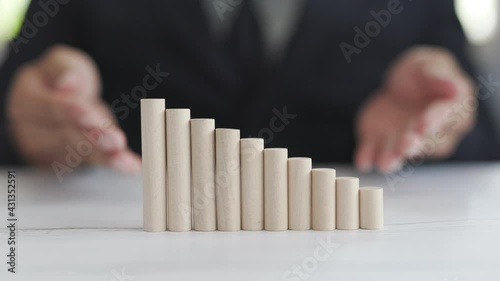 Close up The wooden bars are arranged like a ladder to success. Lying on a wooden table by the window, ideas for running a successful planned business are profitable.