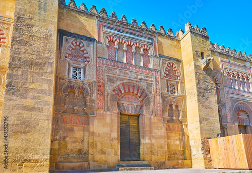 The intricate carved patterns of Puerta de San Nicolas gate of Mezquita, Cordoba, Spain photo