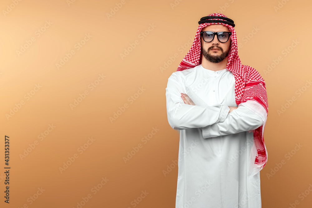 A Saudi Arab man in national dress and sunglasses. Dishdasha, kandora, thobe, islam. Copy space. A Saudi Arab man in national dress and sunglasses. Dishdasha, kandora, thobe, islam. Copy space.