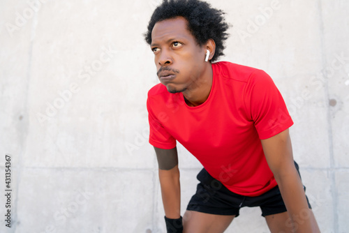 Afro athletic man resting after work out.