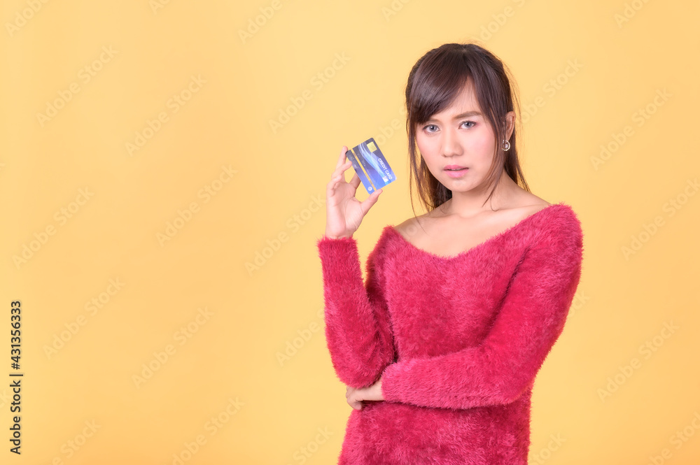 A beautiful Asian woman is happy and thinks that she will spend with many of her credit cards A beautiful Asian woman is happy and thinks that she will spend with many of her credit cards