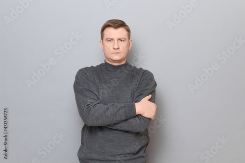 Portrait of blond mature man holding arms crossed on chest