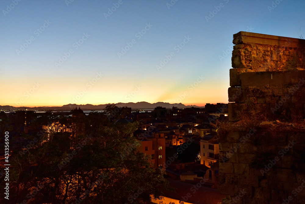 CAGLIARI, ITALY, AUGUST 15, 2019, Panorama of Cagliari old city center during the late sunset, dramatic sky above the biggest city of Sardinia, Italy