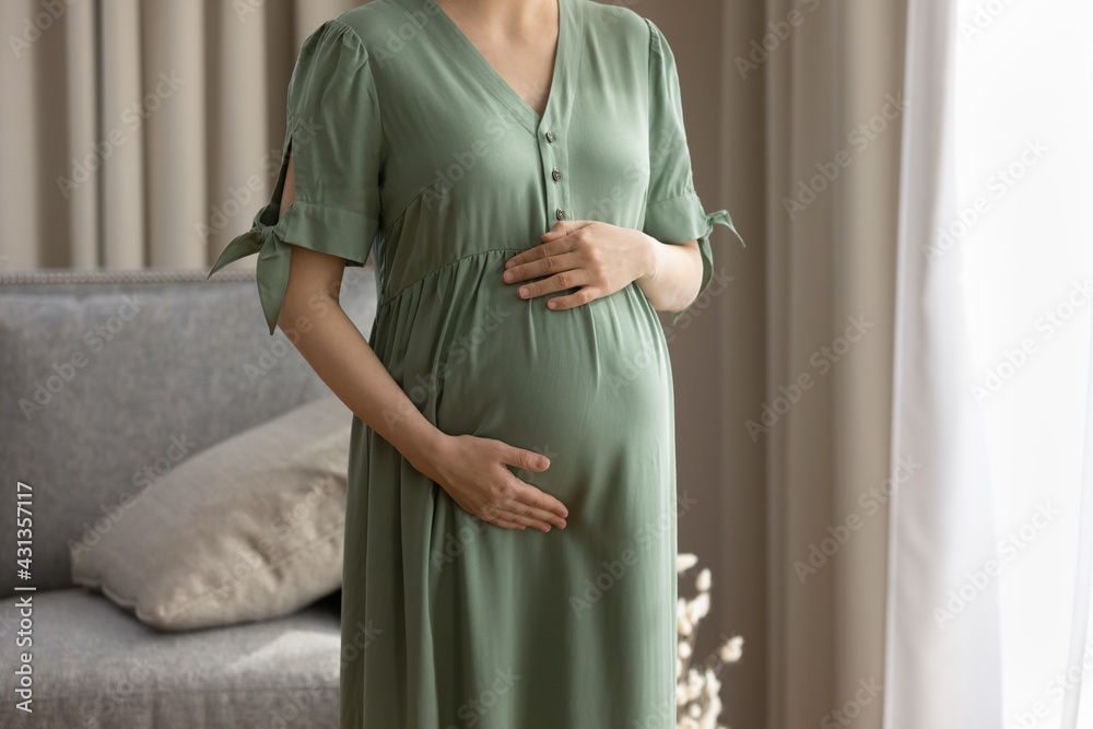 Crop close up of happy young Caucasian woman hold touch baby bump imagine good parenthood. Pregnant female enjoy easy healthy pregnancy caress belly communicate with kid. Motherhood concept. Crop close up of happy young Caucasian woman hold touch baby bump imagine good parenthood. Pregnant female enjoy easy healthy pregnancy caress belly communicate with kid. Motherhood concept.