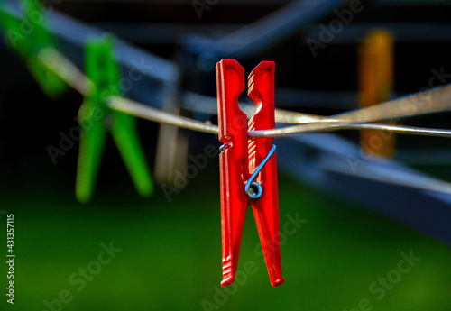Red plastic clothespins on rope