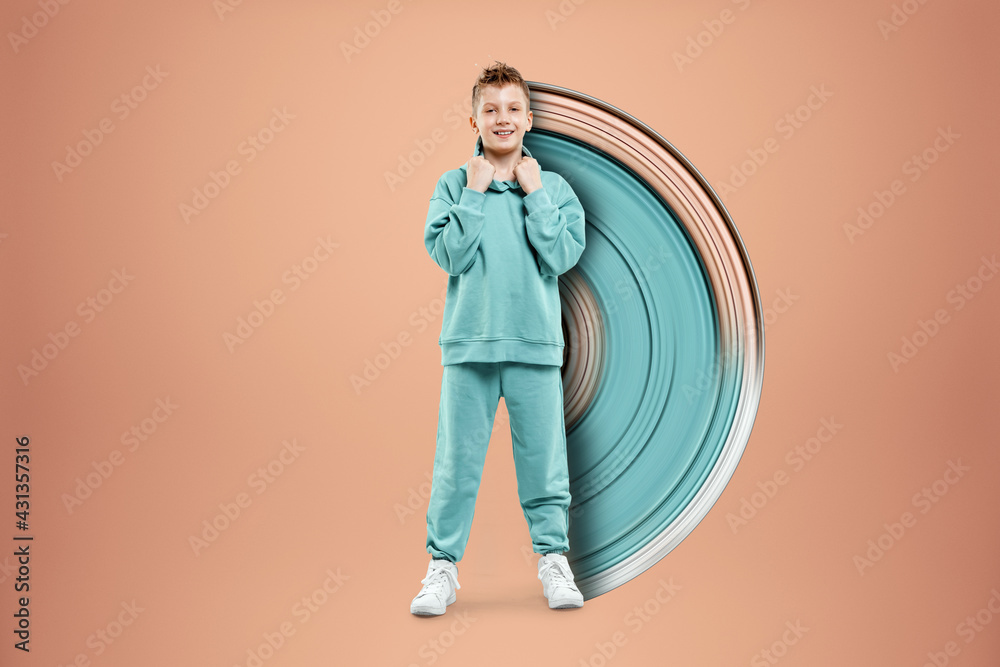 Portrait, cute stylish boy in a blue suit on a beige background. Studio portrait of a child, modern design, trendy background, turquoise. Copy space. Portrait, cute stylish boy in a blue suit on a beige background. Studio portrait of a child, modern design, trendy background, turquoise. Copy space.