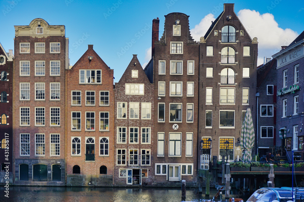 Amsterdam houses on Damrak a partially filled in canal dancing houses with dutch architecture by the canal Amsterdam Holland Netherlands